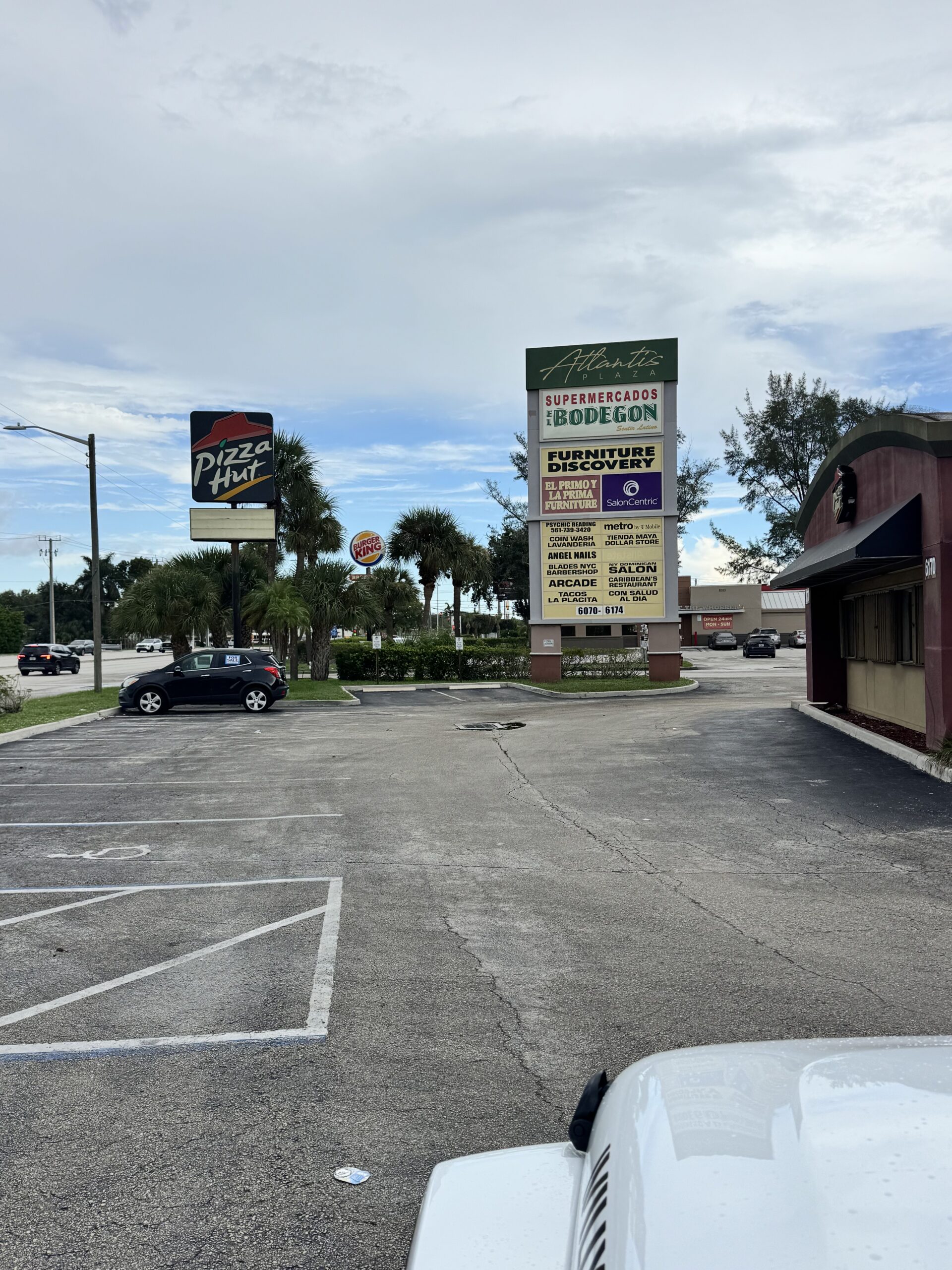 Atlantis Plaza sign and parking lot on South Congress Avenue in Lake Worth